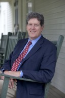 Scott Meiklejohn in green chair outside