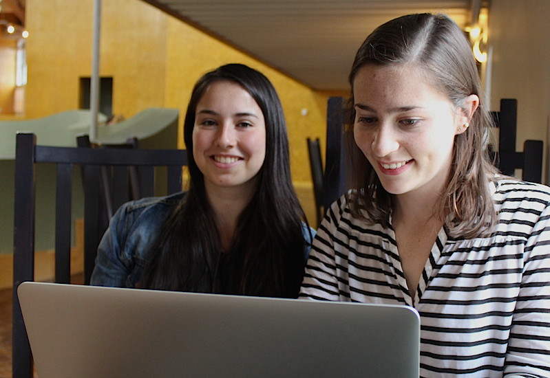 two students looking at computer