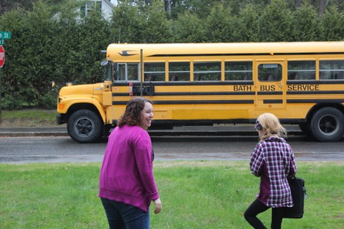 Mentor and student in front of bus