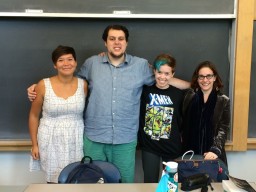 four students in front of chalkboard