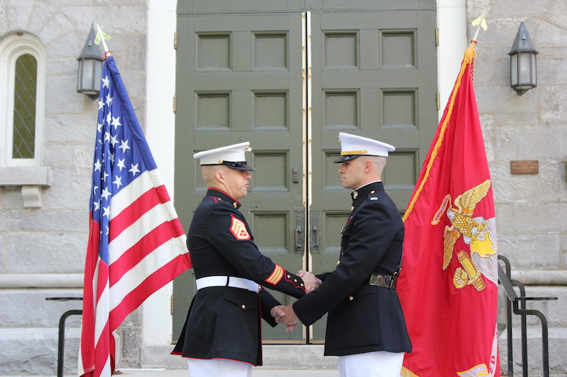 The U.S. Marine Corps held a commissioning ceremony for senior David “Mac” Caputi on Friday morning. Standing before the Bowdoin Chapel, in front of his family, coaches, professors and friends, Caputi took his oath and became a second lieutenant. Caputi’s parents, Beth Caputi and former Bowdoin football coach David Caputi, pinned his rank insignia on his shoulder epaulets. His parents also presented Caputi with a mameluke sword, the oldest type of weapon used by the U.S. armed forces. Caputi trained for two summers at the Officers Candidate School in Quantico, Va., passing the rigorous physical, mental and emotional tests to become an officer. Following graduation, Caputi will attend The Basic School for six months in Quantico, where he will study such topics as leadership, war fighting philosophies, and how to conduct humanitarian operations. After that, he’ll pursue advanced schooling in a particular field. At the conclusion of the ceremony, Caputi thanked the many people — “teachers, professors, advisors, mentors, instructors, marines, coaches, classmates, teammates, friends and family” who he said had inspired him to pursue this path “to become the best man, and now the best Marine Corps officer,” he could be.