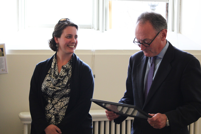 Shana Stewart Deeds receiving a McKeen Award from former Bowdoin President Barry Mills