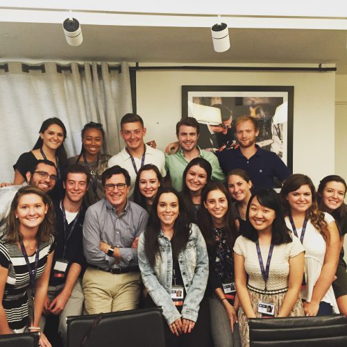 Tom Capone ’17 with other interns and Stephen Colbert. Capone is standing behind Colbert, wearing white T-shirt