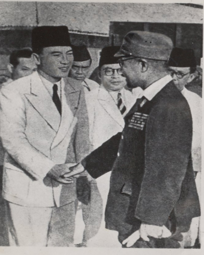 Sukarno (left) greets a Japanese official