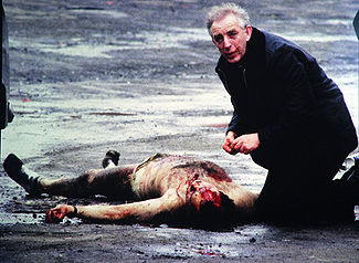Father Alec Reid tends to a fatally wounded British solder, Belfast, 1988