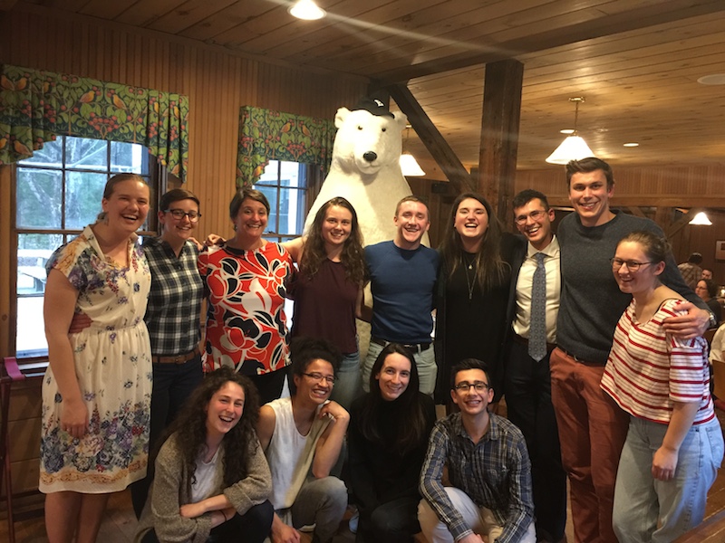 Seniors posing for a photo in front of a polar bear in the Center for Sexual and Gender Diversity.