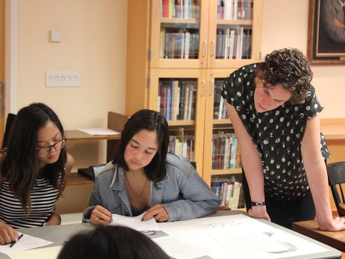 Assistant Professor of Sociology Ingrid Nelson with her students, looking over Special Collections material