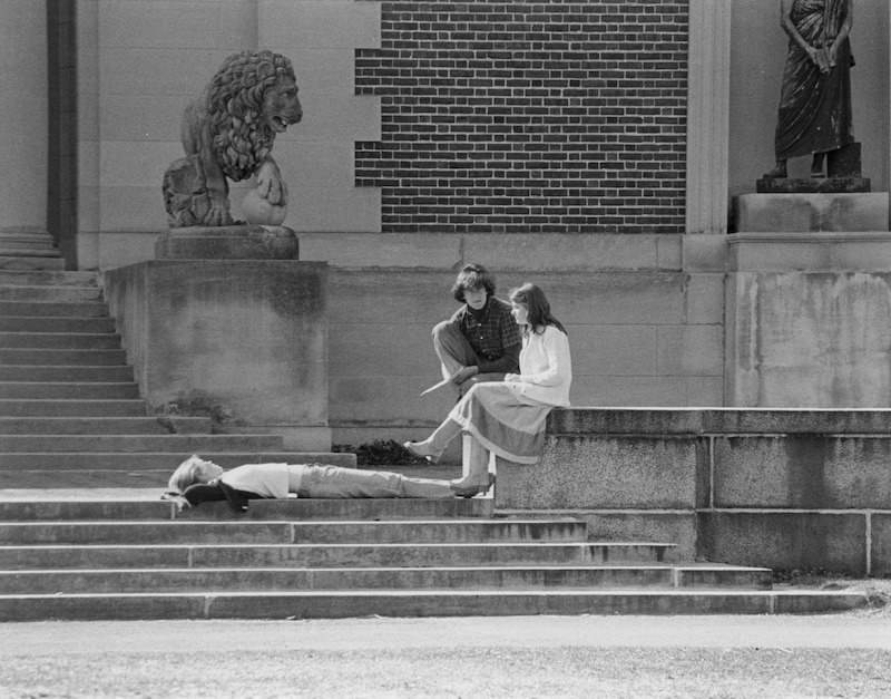 Tthe Walker Art Building and students relaxing in the sun, undated.