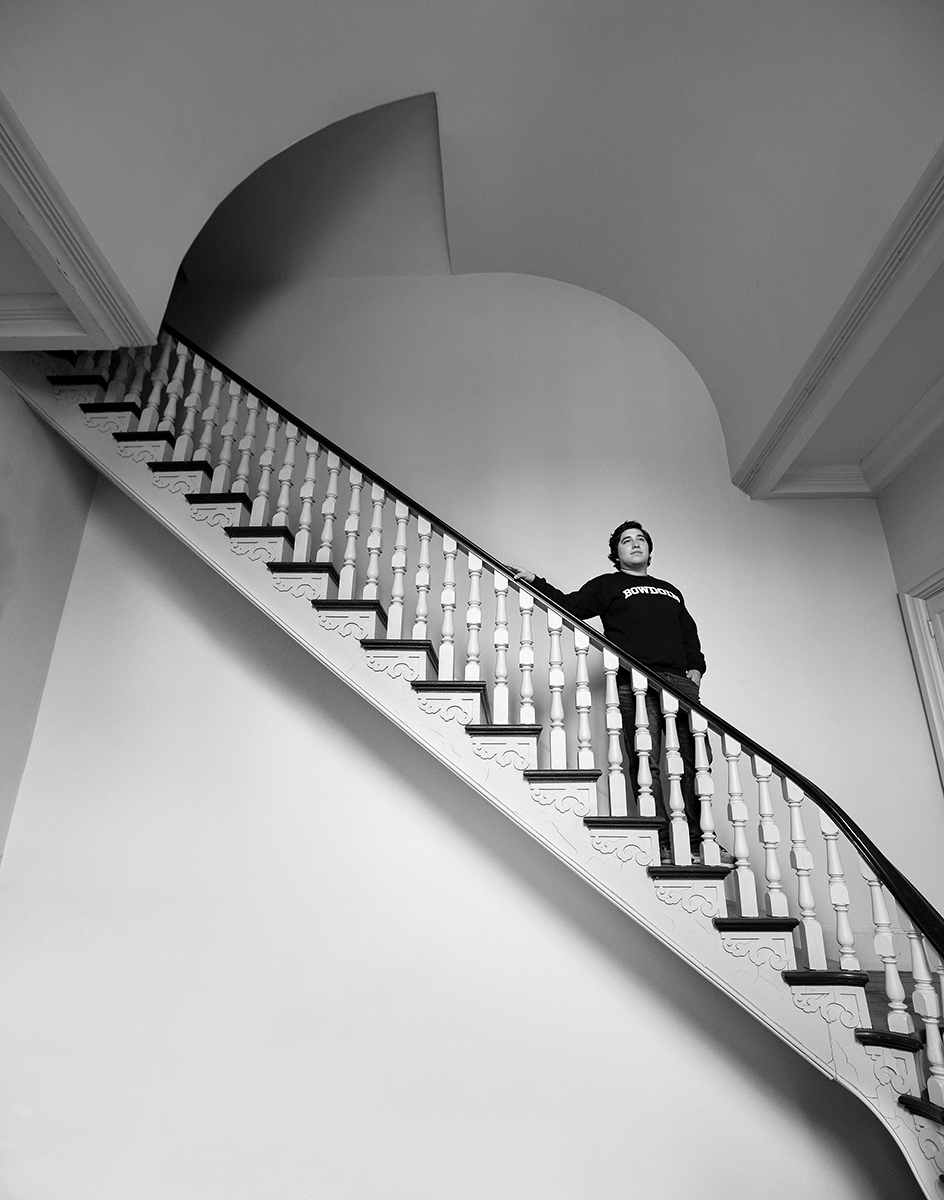 Jorge stands at the top of the McKeen Center stairs