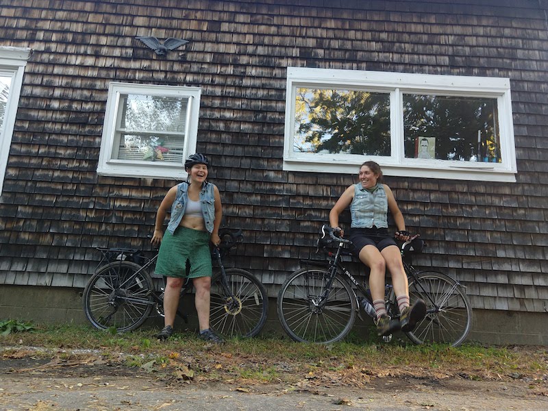 Ali Briere and Danielle Walczak standing by bikes