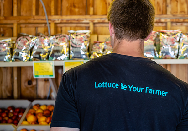 Trevor's back, with his shirt that reads "Lettuce Be Your Farmer"