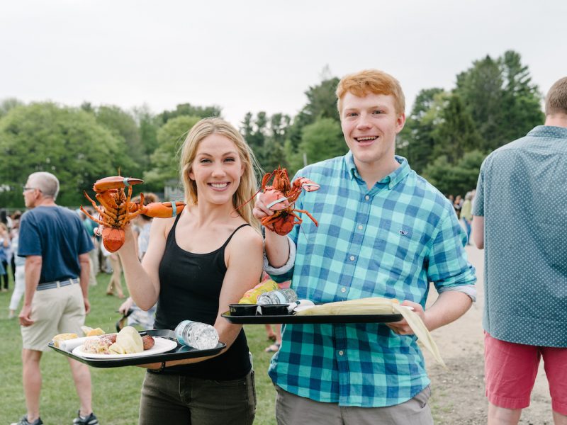 people posing with lobsters