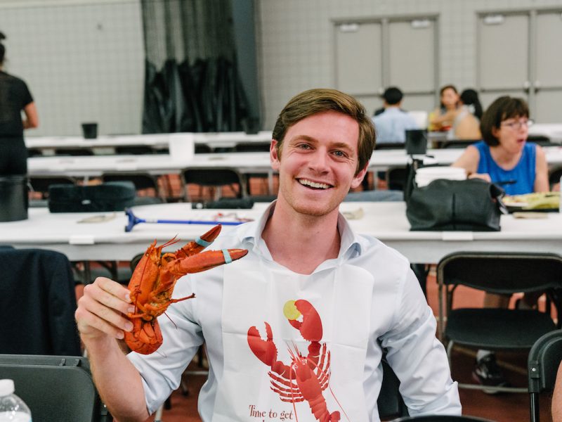person posing with lobster