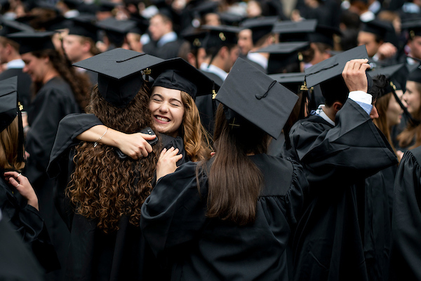 graduates hugging