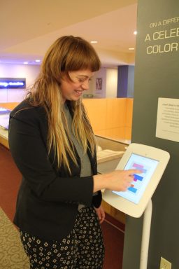 Librarian Marieke Van Der Steenhoven tries out an interactive app at the exhibit