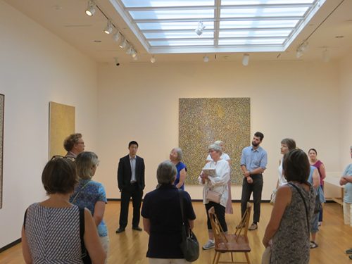 Visitors enjoy the exhibition “Richard Pousette-Dart: Painting/Light/Space” at the Bowdoin College Museum of Art.