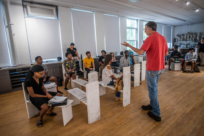 Mike Kolster, professor of art, addresses the Geoffrey Canada Scholars in their combined math and photography class