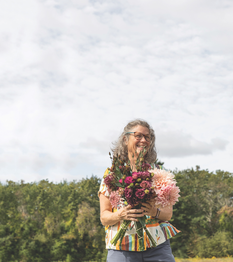 Amy Maloney holding a bouquet of flowers