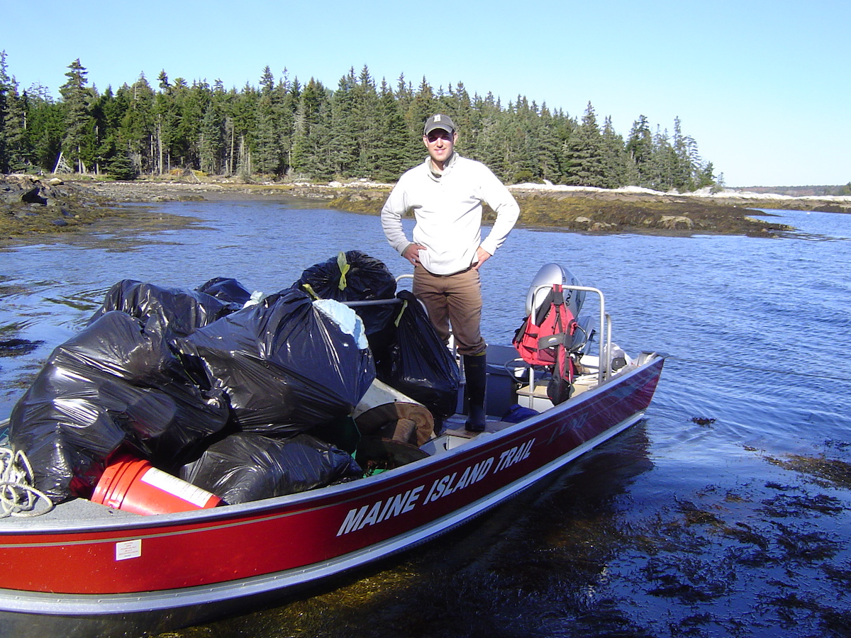 Brian Marcaurelle with collected garbage on a boat