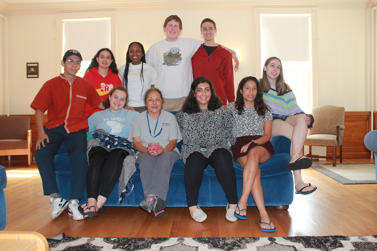 A group of students pose with their House's housekeeper