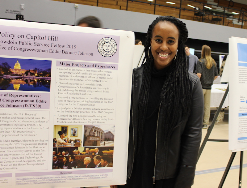 Eskedar Girmash standing with her symposium poster