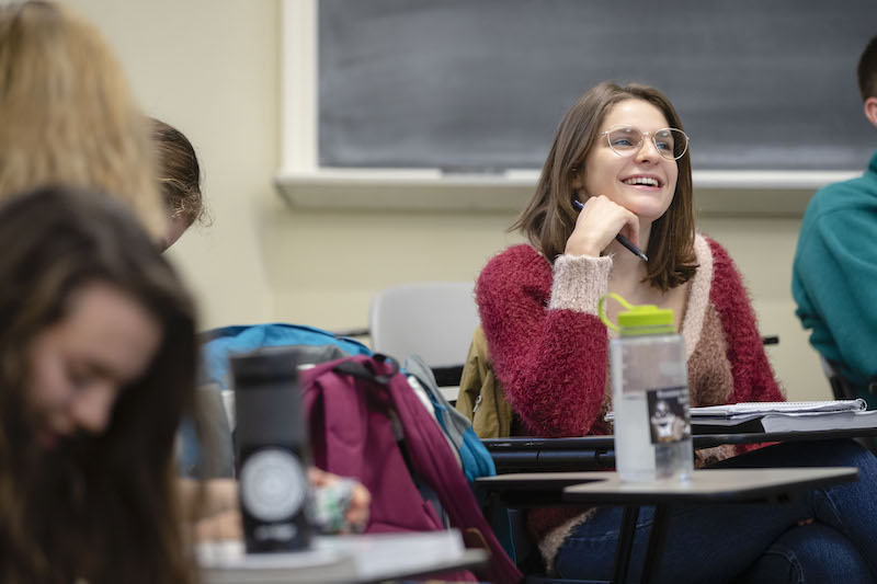 Female student laughs in class