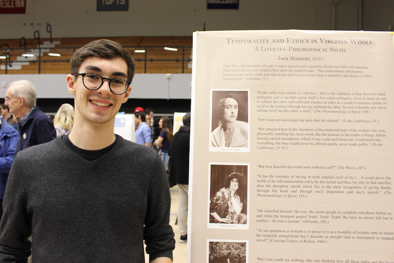 Jack Rogers in front of his poster