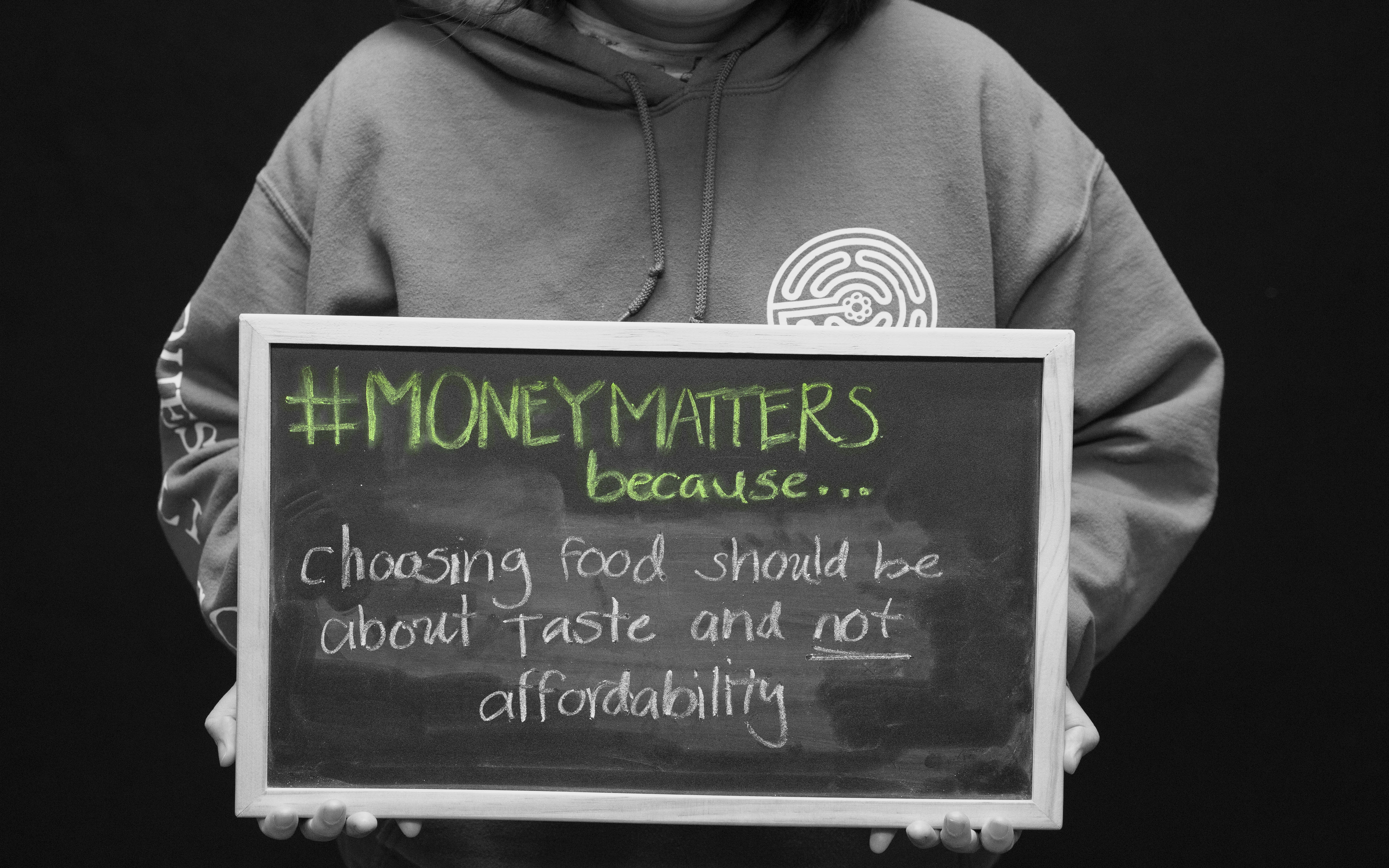 Student showing statement on chalkboard