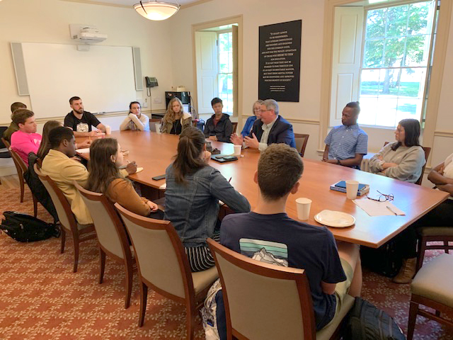 Rich Littlehale meets with students at a conference table in Massachusetts Hall