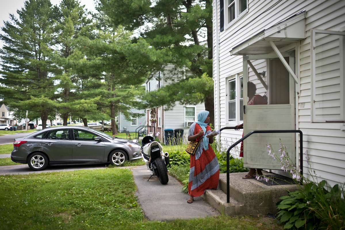 Usira Ali talking to woman in her house