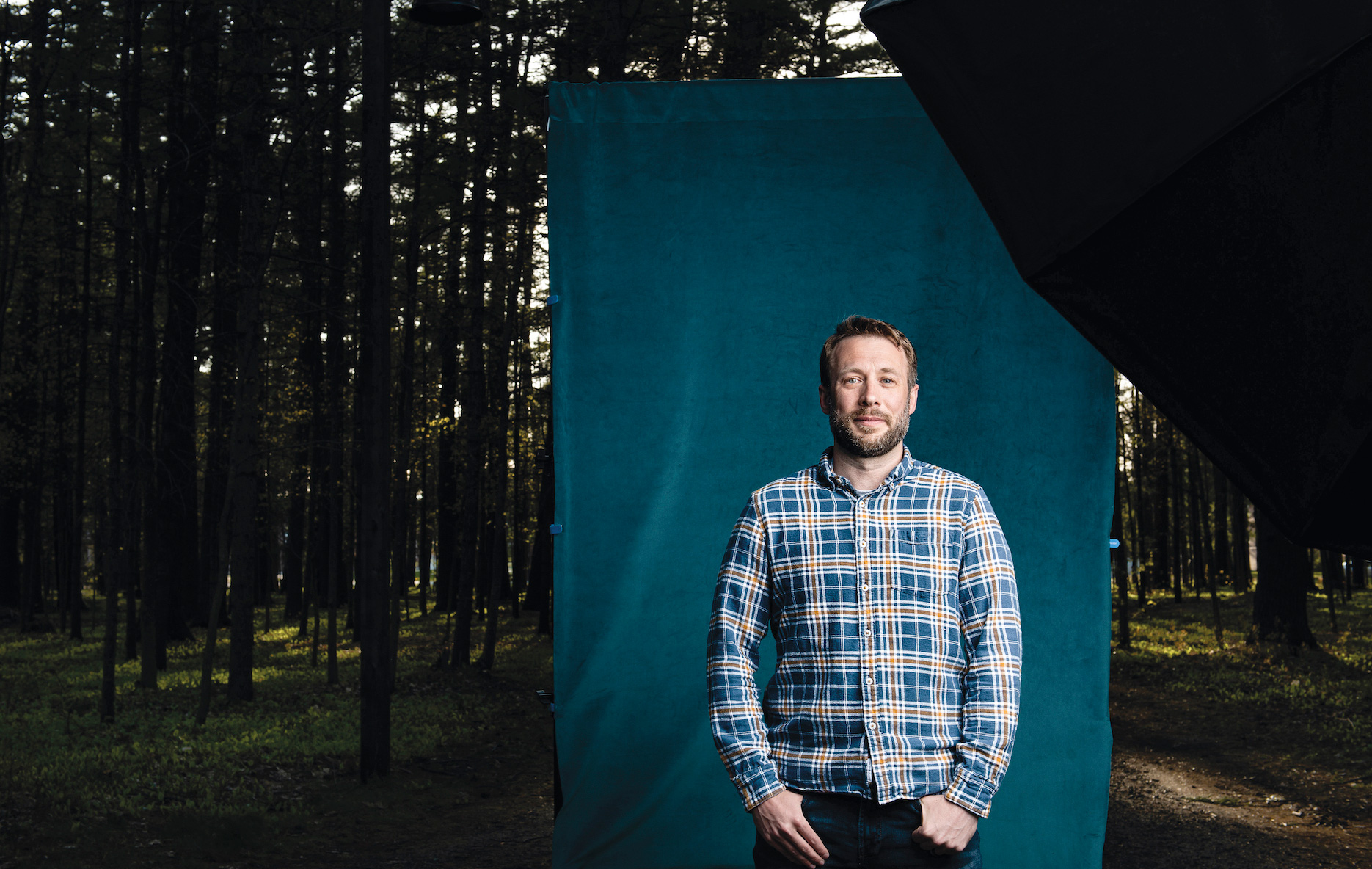 Ben Martens ’06, standing in the Bowdoin Pines