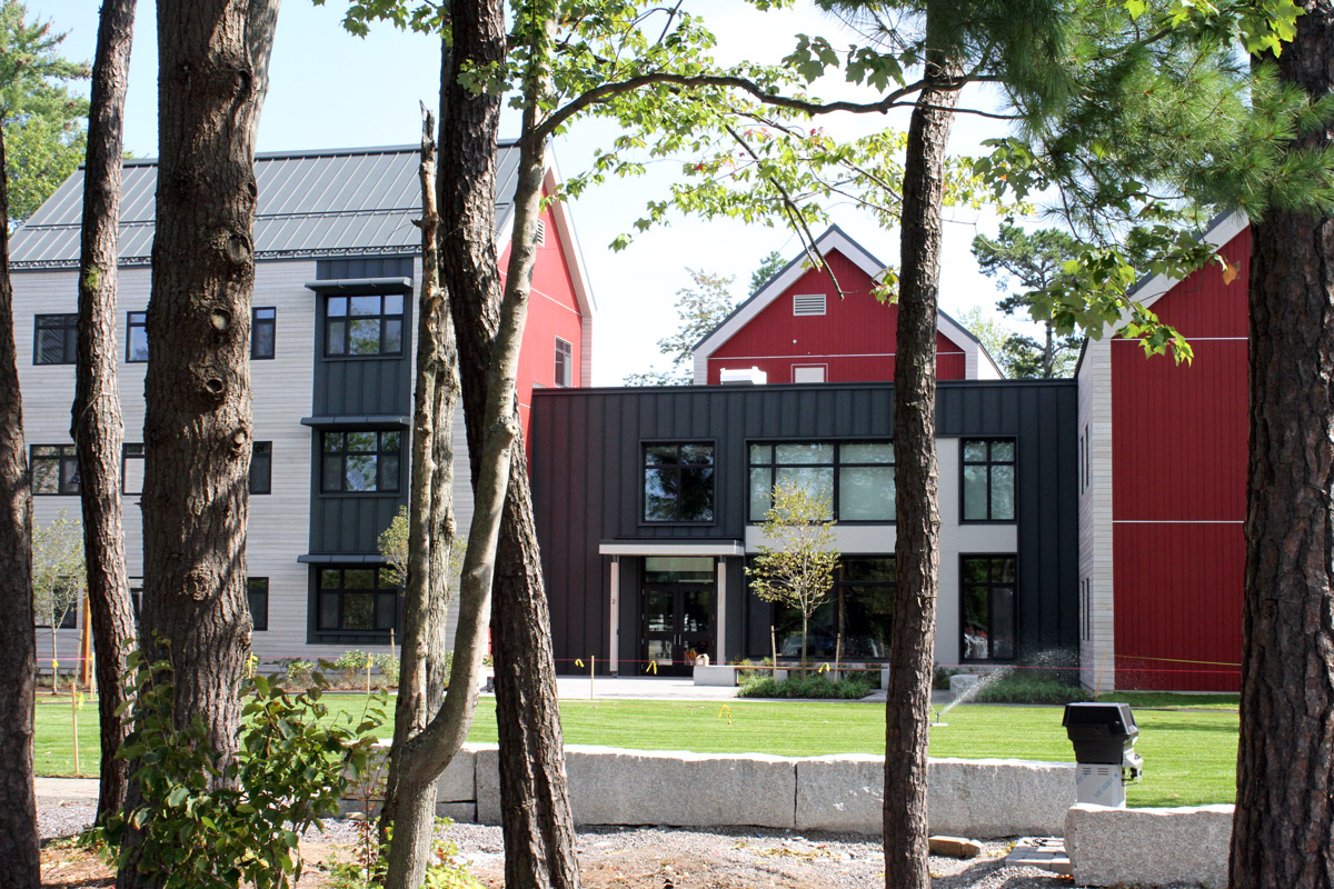 Exterior view of Harpswell Apartments through the pines.