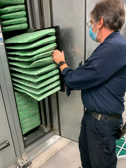 Mechanical Services Technician Rich McKeen checks MERV-14 filters in the Peter Buck Center for Health and Wellness.