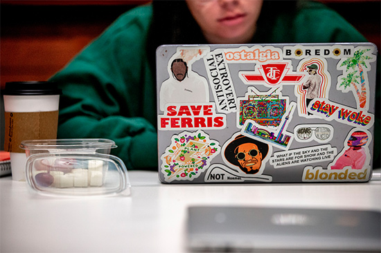 A student's laptop covered in stickers