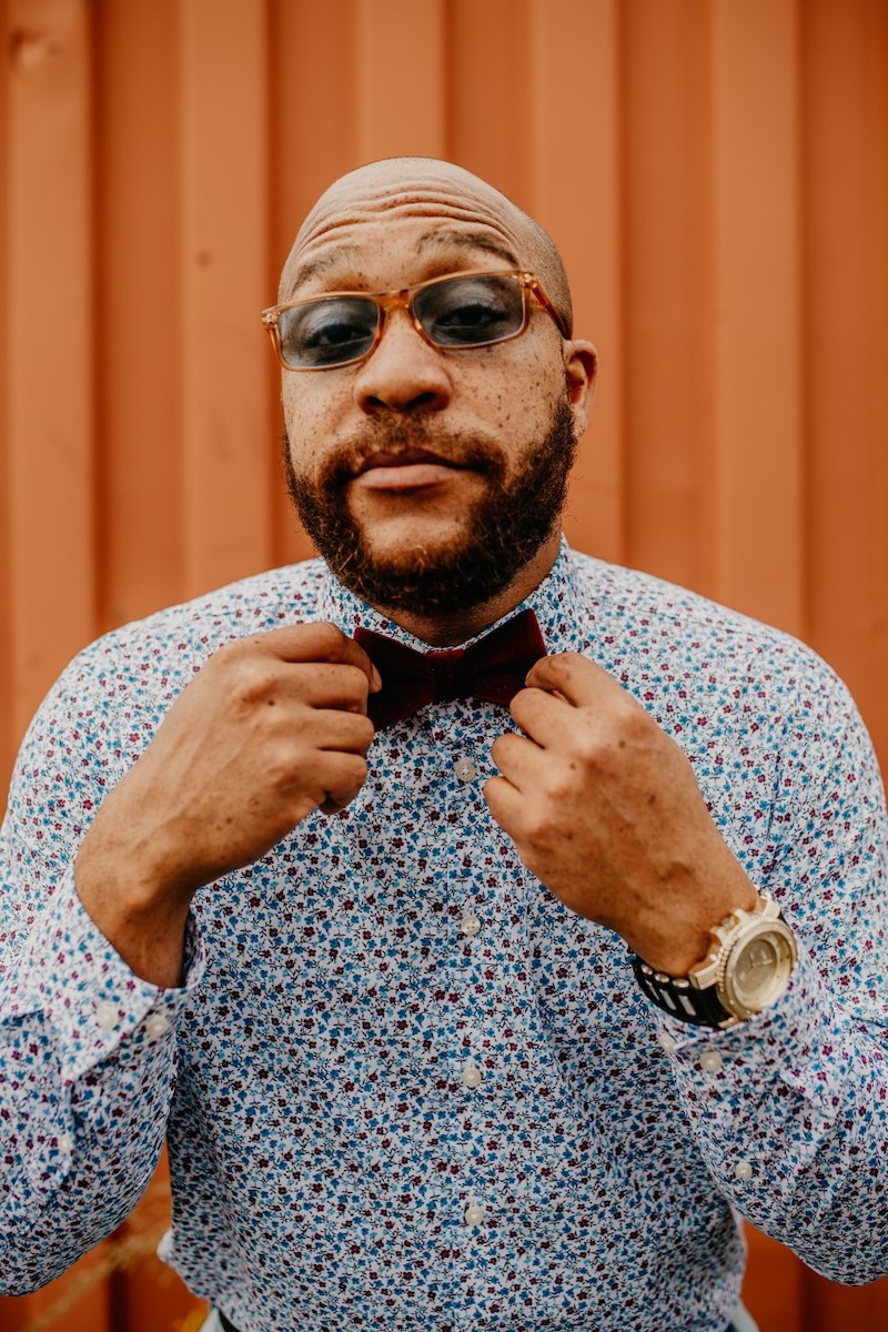 Genius Black adjusts his bowtie