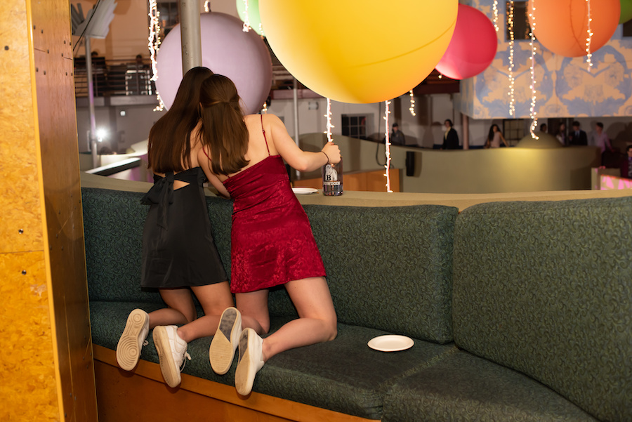 Two students looking down on the festivities 