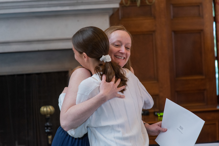 McKeen Center director Sarah Seames hugs Elise Hocking