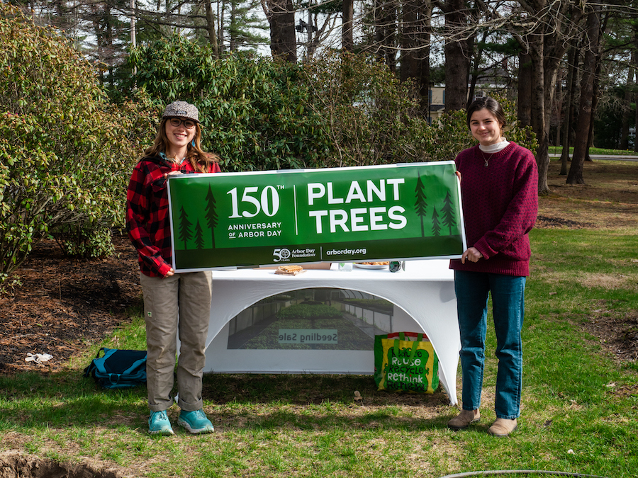 students hold up a tree sign