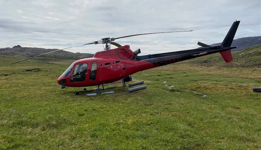 helicopter landing down on a carpet of green