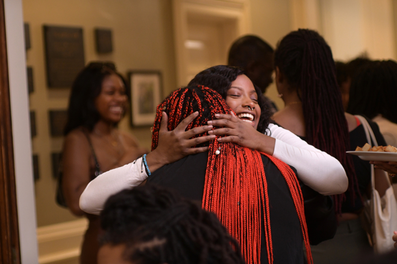 Black alumni hug