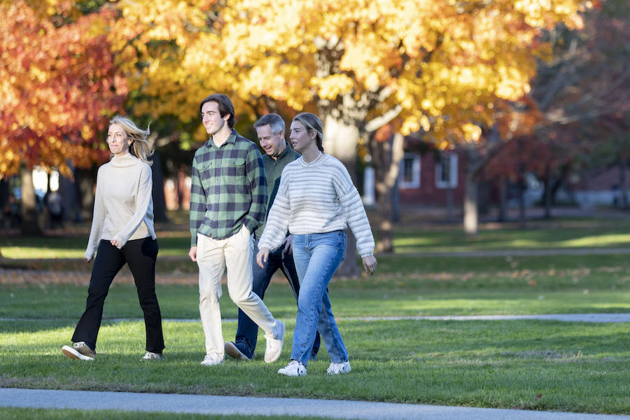 A family walks across the quad