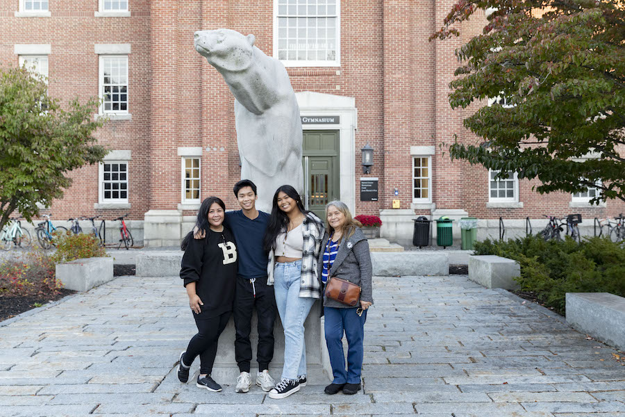 A family poses in front of the polar bear