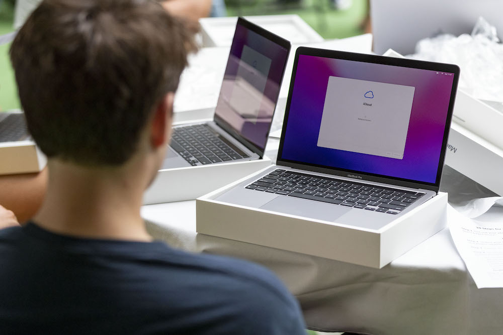 Student sitting with new MacBook Pro