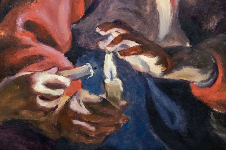 A close-up of a painting depicting hands over a candle flame