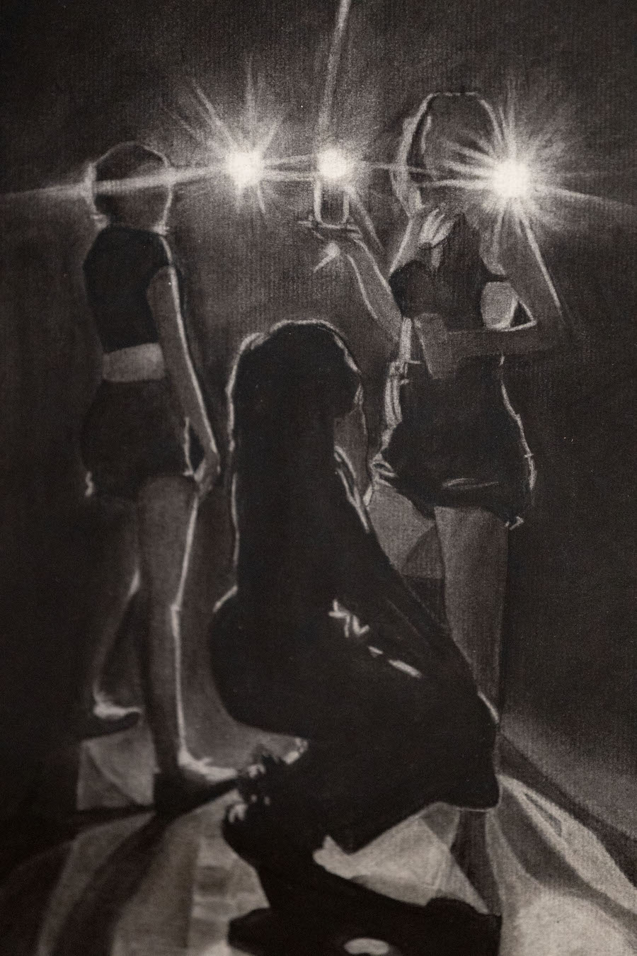 Charcoal drawing of three female dancers holding lights