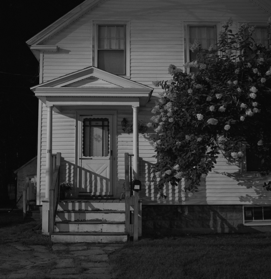 A black-and-white untitled print of the front of a house from Chris Zhang's Midnight Penumbra show