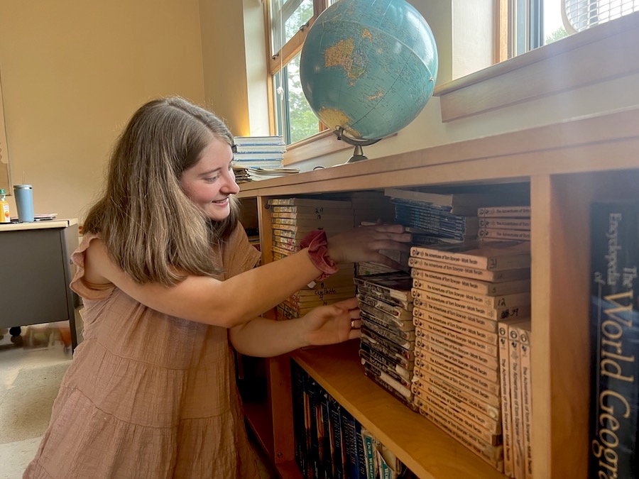 Emery with the books she'll assign her students