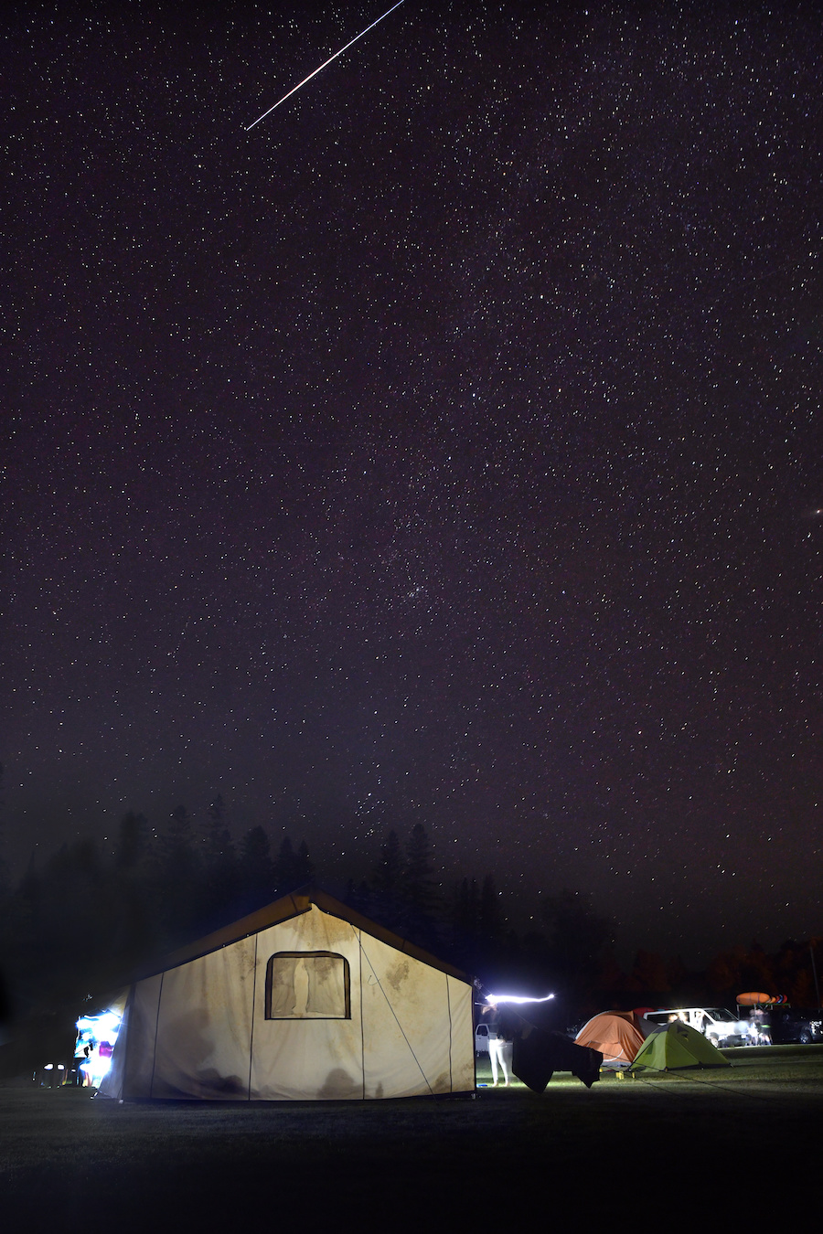 shooting star above a tent during an orientation trip