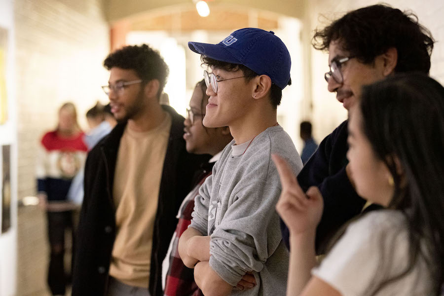 students look on together at an artwork