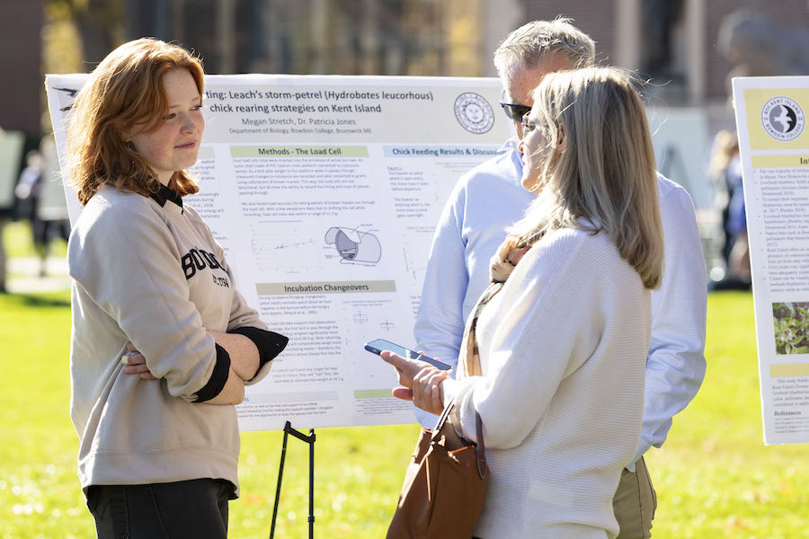 Student chats at symposium